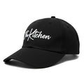 Black cap with 'The Kitchen' text on a white background