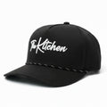 Black cap with 'The Kitchen' logo on a white background