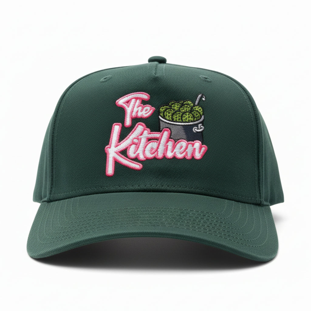 Green cap with 'The Kitchen' embroidery on a white background