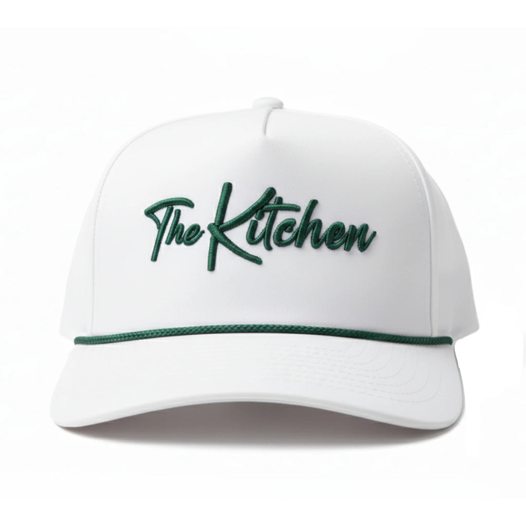 White cap with 'The Kitchen' text in green on a white background