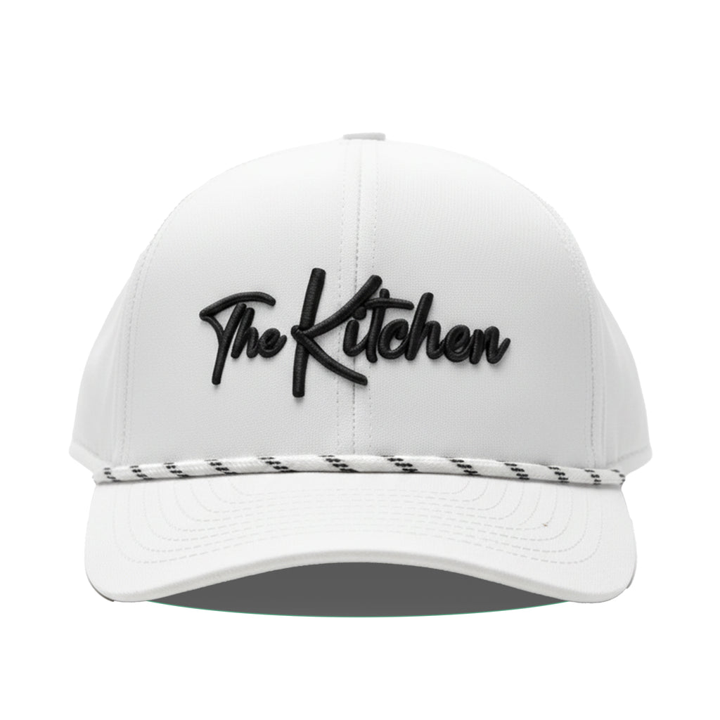 White cap with 'The Kitchen' logo on a white background
