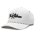 White cap with 'The Kitchen' logo on a white background